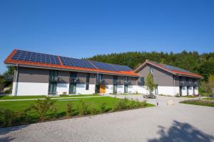 米斯巴赫Leo Apartments Miesbach的屋顶上设有太阳能电池板的建筑