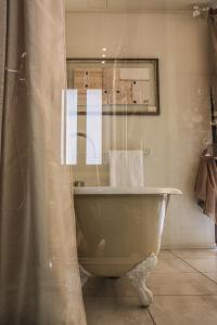 伊夫雷亚斯帕齐奥[比安科]酒店的带浴缸和浴帘的浴室
