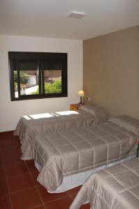 萨尔塔Departamentos Ibazeta的带窗户的客房内的三张床