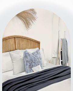 凯阿玛Oceanview Kiama Luxury Coastal Accommodation的一张带白色枕头的床和一本书