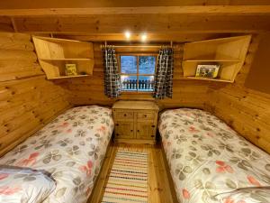 BaierdorfFerienhütte Bosic的小木屋内一间卧室,配有两张床