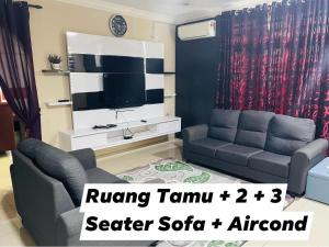 卢穆特No 11 Nazirin Homestay Tmn Desa Manjung Lumut的带沙发和电视的客厅