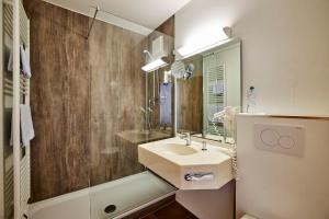 卡尔斯费尔德斯威特费姆酒店的一间带水槽和镜子的浴室