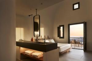 费拉Orama Hotel & Spa的一间带水槽的浴室和一张美景床。