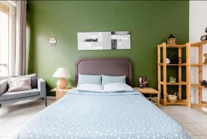 瓦朗西纳Apt Chic, 60m2, 2 Chambres, Centre的一间卧室设有一张床和绿色的墙壁