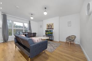 查塔姆Suites by Rehoboth - Medway Heights - Chatham Kent的客厅配有沙发和桌子