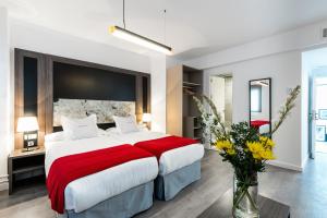塞维利亚塞维利亚酒店的一间卧室配有一张带红色毯子的大床