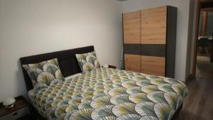 莫雷兹Apart'Bellevue的卧室内的一张带被子和梳妆台的床