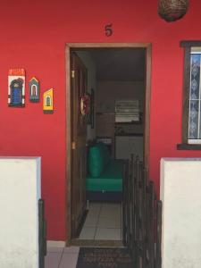 塞拉Casa quadra praia Jacaraipe的一道门,进入一个红色墙壁的房间