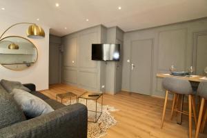 尼斯Lovely Apartment Heart of Golden Square Fiber Wifi的客厅配有沙发和桌子