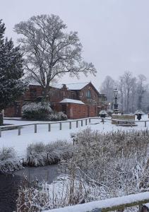 斯托克波特布雷德贝里豪尔酒店的一座建筑物前的积雪覆盖的公园