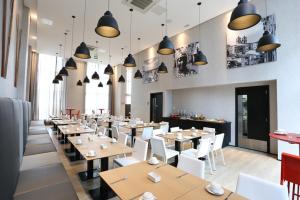 萨尔瓦多Salvador Mondial Flats的餐厅设有木桌和白色的椅子及灯