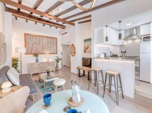 马略卡岛帕尔马Spot Apartment的客厅以及带沙发和桌子的厨房。