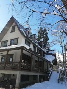 白马村Pilot Lodge的一座白色的大房子,里面积雪