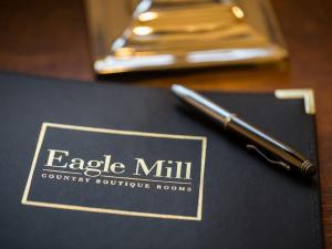 亨廷登Eagle Mill Luxury Rooms的桌子上笔记本上边的笔