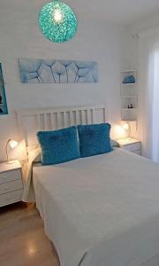 佩尼斯科拉Apartamento El Príncipe的一间卧室配有白色床和蓝色枕头