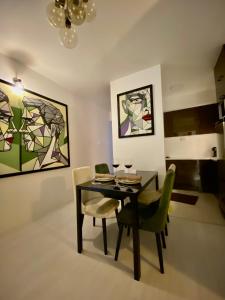 什蒂普Sandev Apartments的一间带桌椅和绘画的用餐室