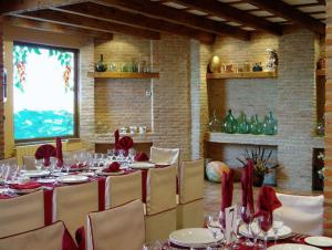 莱昂Hotel Las Moreras的用餐室配有红色餐巾和长桌