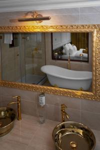 巴尼亚卢卡Hotel Integra Banja Luka的浴室设有水槽和镜子内的浴缸