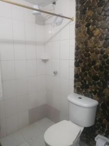 米卡Casa chill out的浴室配有白色卫生间和石墙。