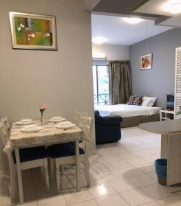 武吉丁宜Bukit Tinggi 1 Hati guesthouse的客厅配有桌子和床。