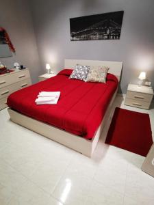卡塞塔B&b Ci Vediamo Da Mario的一间卧室配有一张红色大床和红色毯子