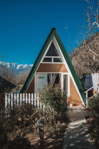 马拉里Enthralling Escapes Nature Stay and Trek的一座带绿色屋顶和围栏的小房子
