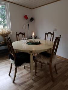 霍森斯Keramikhuset 2 komma 0, smuk natur og hjemlig hygge的餐桌,配有蜡烛和椅子
