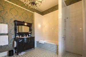 皇后镇Hulbert House Luxury Boutique Lodge Queenstown的带淋浴、盥洗盆和镜子的浴室