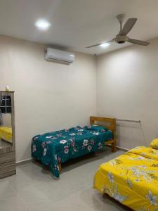 马六甲VILLA D' KEBUN WITH FREE FRUITS的一间卧室配有两张床和吊扇