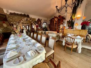 凯里尼亚Bellapais Gardens的一间用餐室,配有长桌和白色菜肴