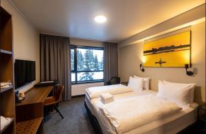 雷克霍特Blue Hotel Fagrilundur - On The Golden Circle的配有一张床、一张书桌和一扇窗户的酒店客房