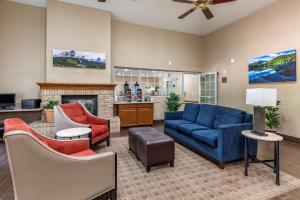 柯林斯堡Comfort Suites Fort Collins Near University的客厅配有蓝色的沙发和椅子