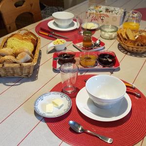 Anchenoncourt-et-ChazelLa Grange Des Roches Roses的餐桌,盘子,碗,食物和面包