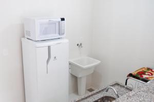 彼得罗波利斯Apartamento aconchegante的卫生间的顶部设有带微波炉的浴室。