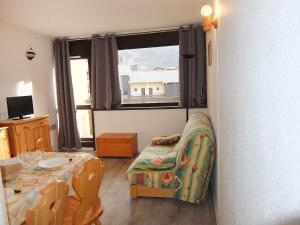 里蒙纽耶Apartment Les Asters-31 by Interhome的客房设有桌子、椅子和窗户。