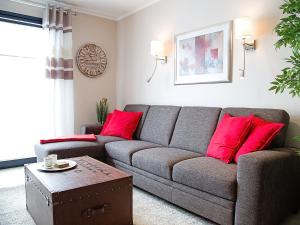 诺德代希Apartment Witthuus-Norderney by Interhome的带沙发和红色枕头的客厅