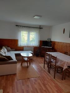 新瓦罗什Domaćinstvo Sindžirević的客厅配有桌子和沙发