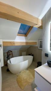 梅杰夫Reine Sophie的浴室配有大型白色浴缸,设有天花板