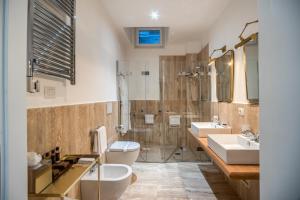 罗马The Talent Hotel的一间带两个盥洗盆、淋浴和卫生间的浴室
