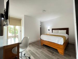 库利亚坎Neo Business Hotel的一间卧室配有一张床、一张书桌和一张书桌