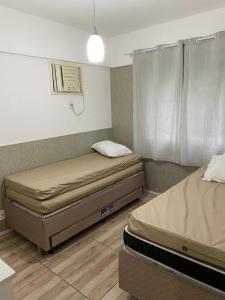 Porto Real Suites Mangaratiba客房内的一张或多张床位