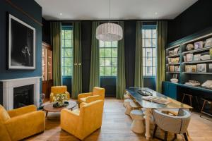 爱丁堡仕骅廷古城钱伯斯酒店公寓的客厅拥有蓝色的墙壁和桌椅