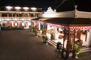 岩望Daroessalam Syariah Heritage Hotel的夜间在建筑物前的一条空的街道
