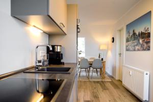 温特贝格Smart Resorts Haus Saphir Ferienwohnung 512的厨房配有水槽和桌椅