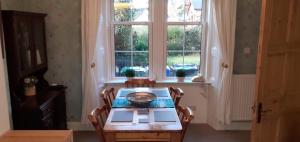 卡伦德Andreu Cottage的一间带桌子和窗户的用餐室