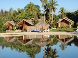 维拉港MG Cocomo Resort Vanuatu的水体中反射的度假胜地