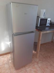 基特曼斯胡普OrbanLife Lite Keetmanshoop的厨房里配有冰箱,厨房旁边设有微波炉