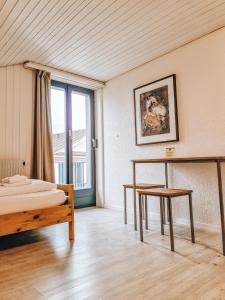 恩特勒布赫Drei Könige的一间卧室配有一张床、一张桌子和一个窗户。