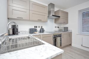 赫尔Luxury Duplex 2-Bed Apartment Fruit Market Marina的厨房配有白色橱柜和洗碗机。